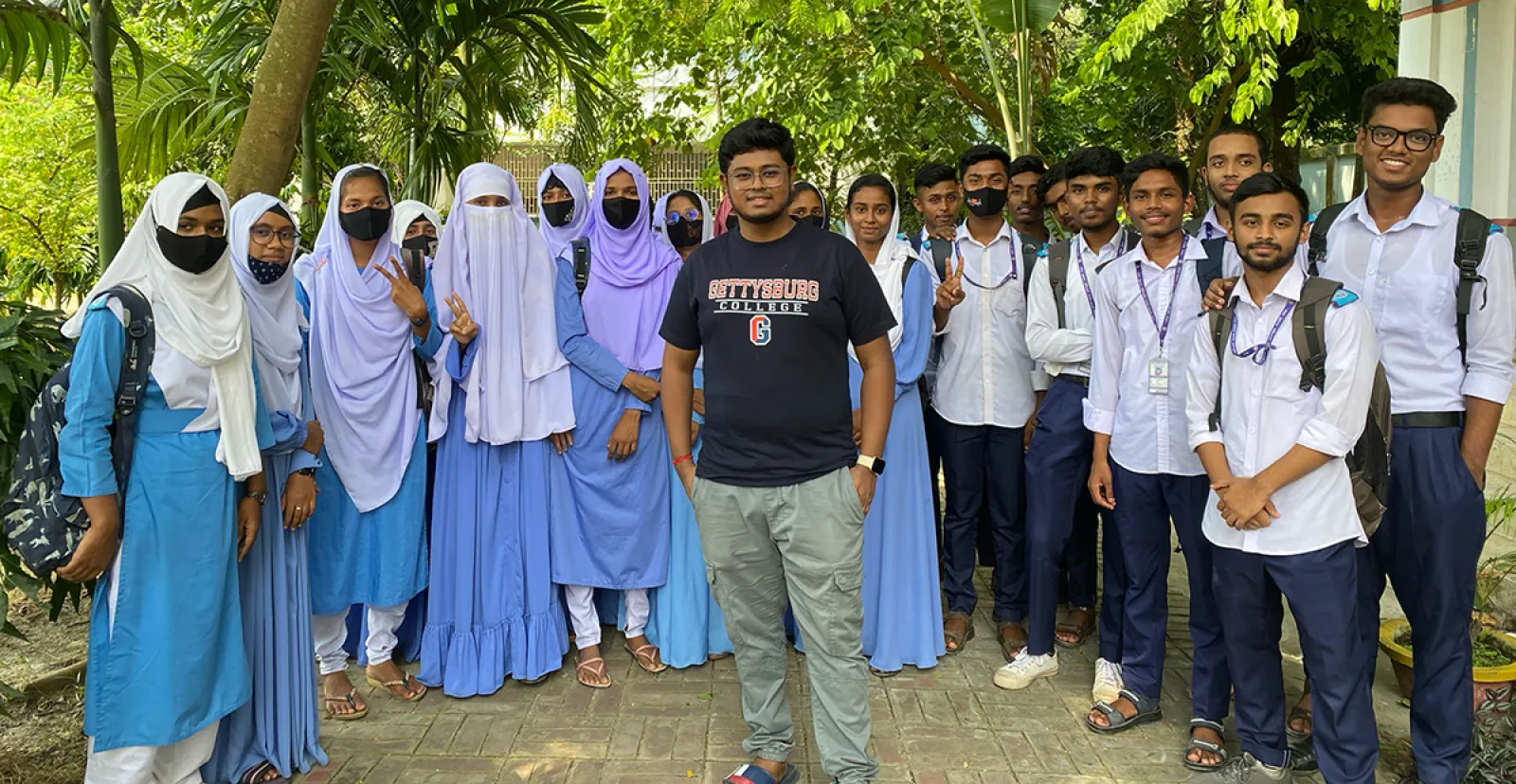 Pronob Sarker ’26 with students.
