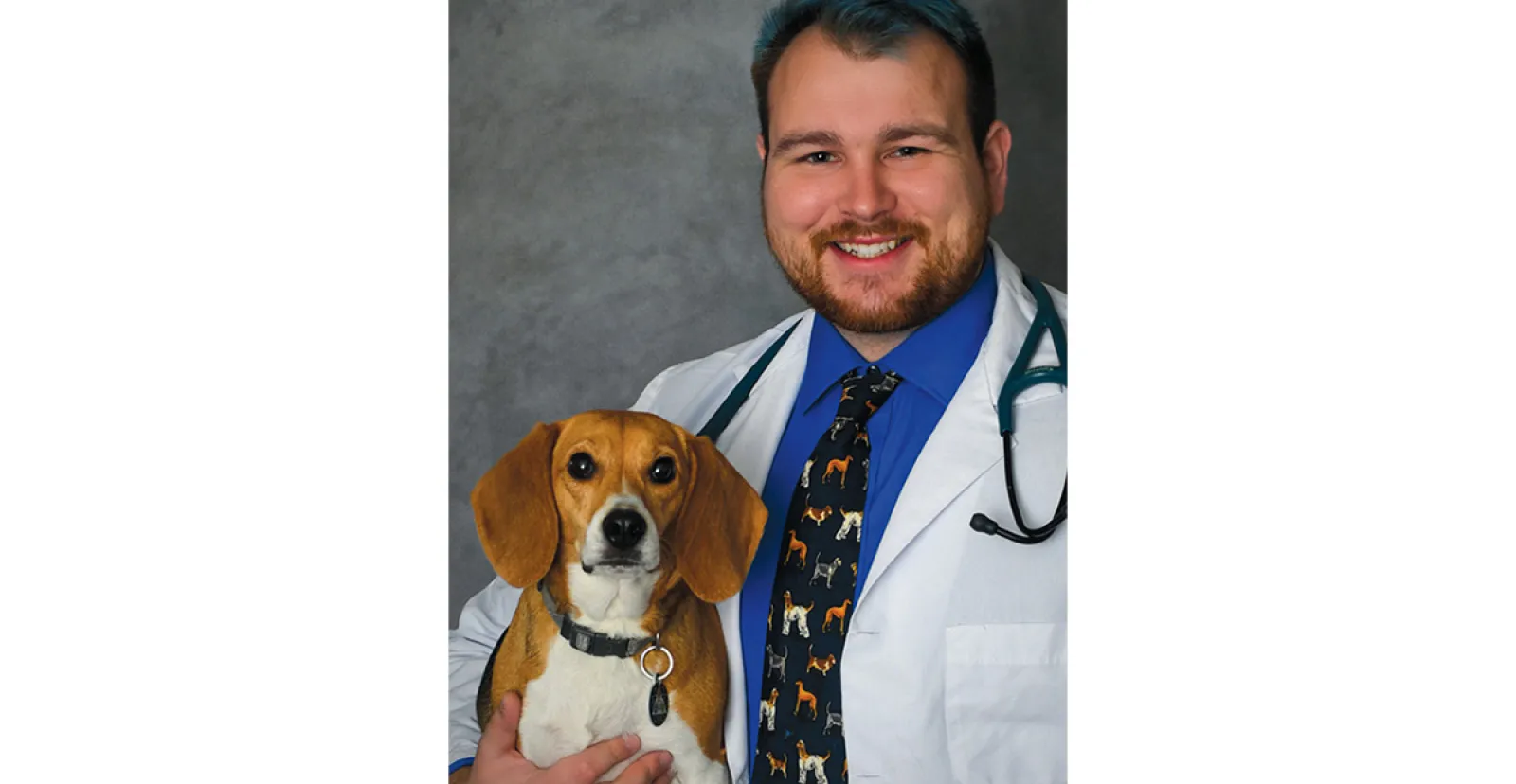 A photo of Dr. Mike Karchner ’19 holding his beagle, Hazel