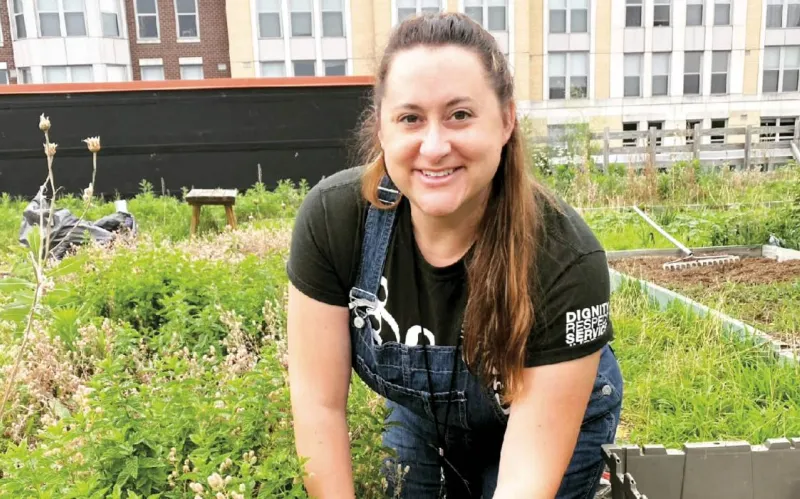Ashley Domm ’07 works in Bread for the City’s rooftop garden.