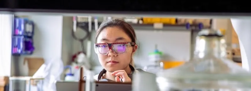 student in goggles in lab