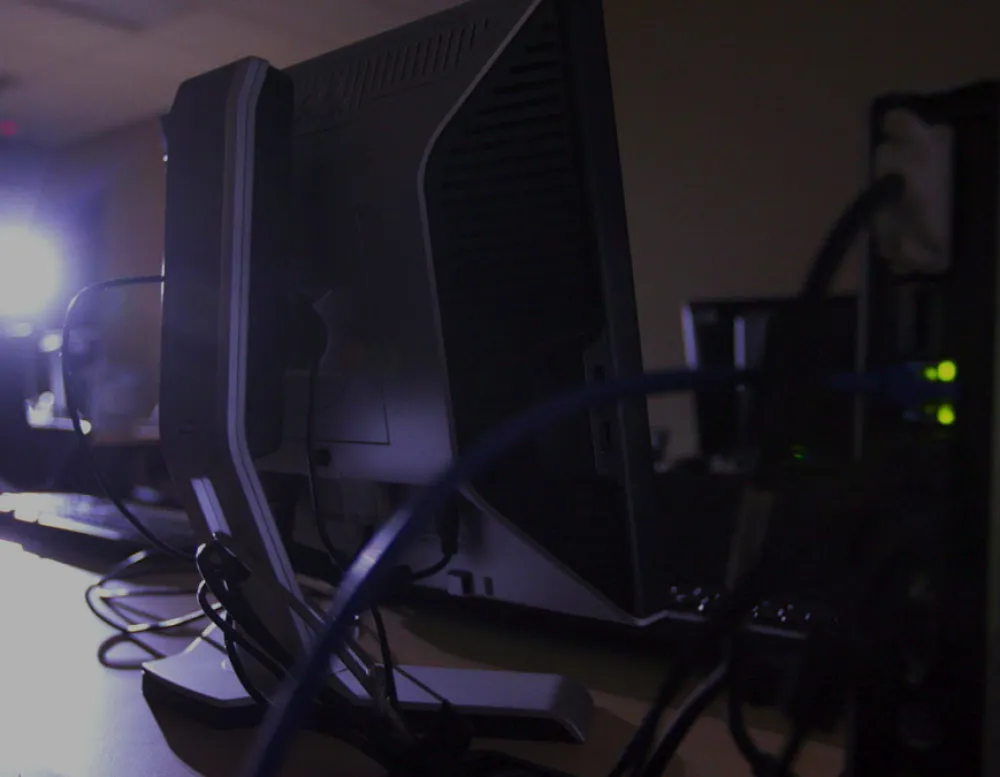 still of back of computer display in back-lit room