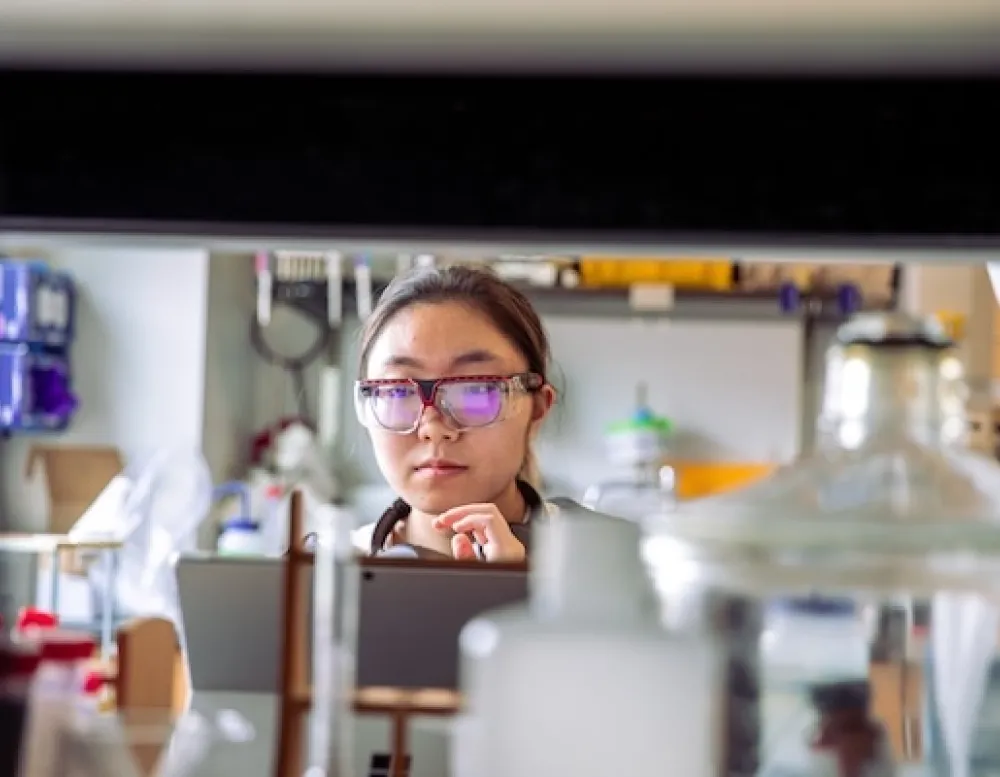 student in goggles in lab
